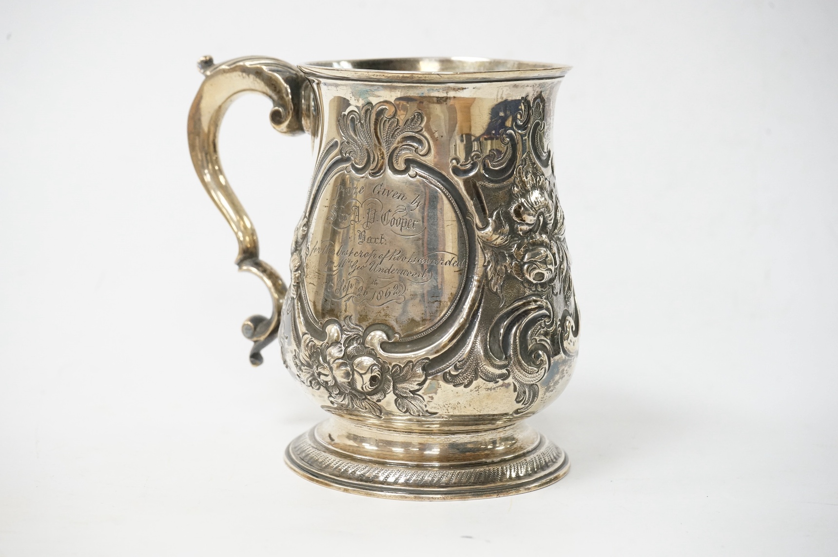 A George III silver baluster mug, with later embossed decoration and later engraved inscription, William Skeen, London, 1766, 12.6cm, 11.3oz. Condition - fair